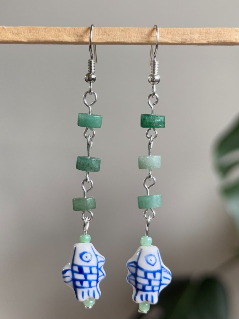 handmade earrings with green heishi beads & dangling blue & white ceramic fish